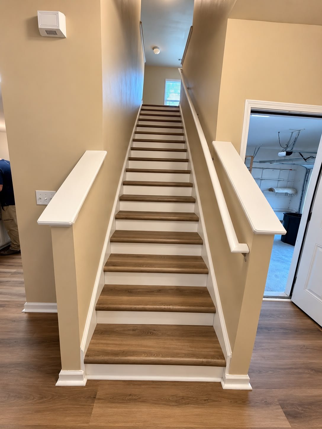Completed staircase with LVP-finished treads and refreshed white trim